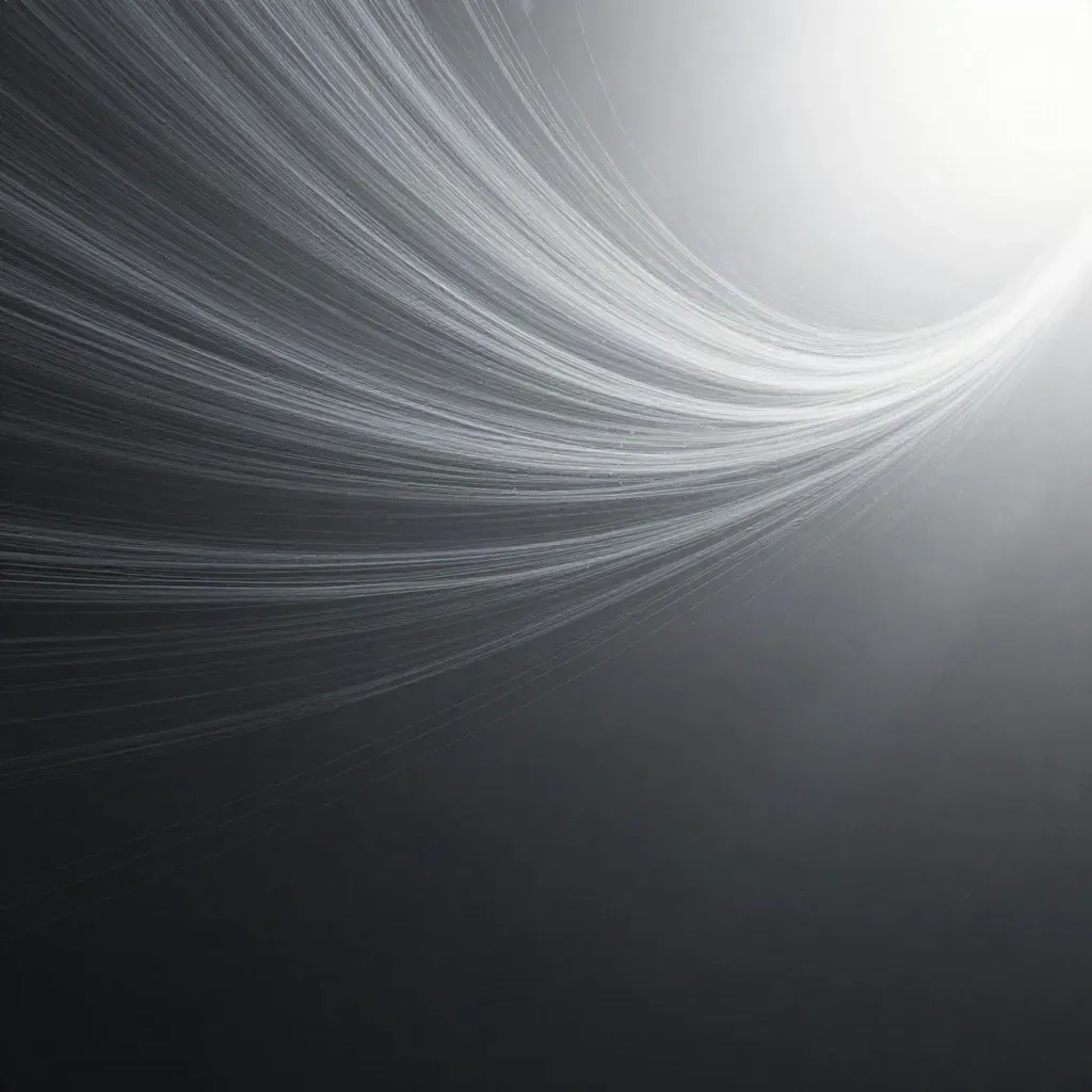 Silver filaments stream through graphite haze into a soft white bloom with drifting motes.